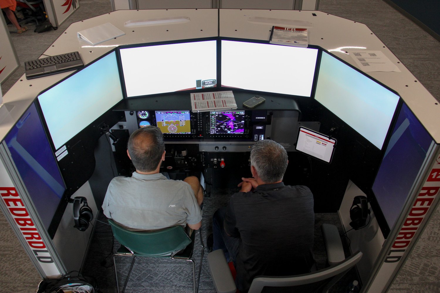 Pilot and CFI training an IFR scenario on a Redbird LD